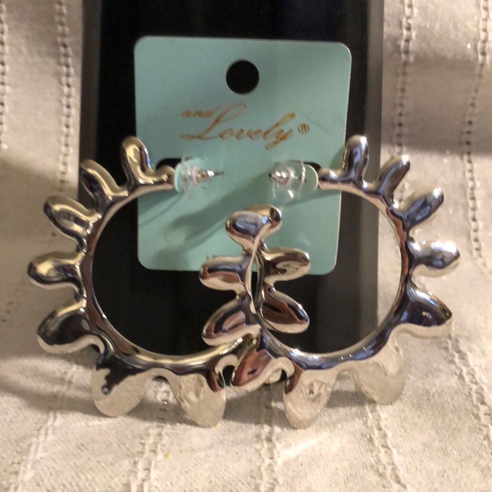 Silver tone large hoop earrings.